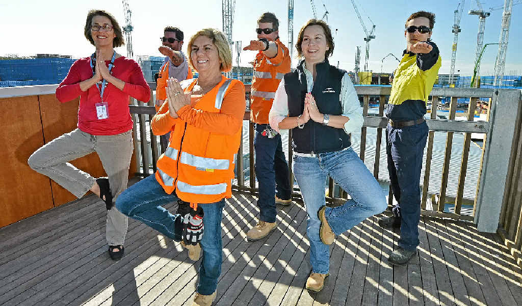 Public hospital builders strike a yoga pose as part of the new healthy eating and exercise campaign. Public hospital builders strike a yoga pose as part of the new healthy eating and exercise campaign.